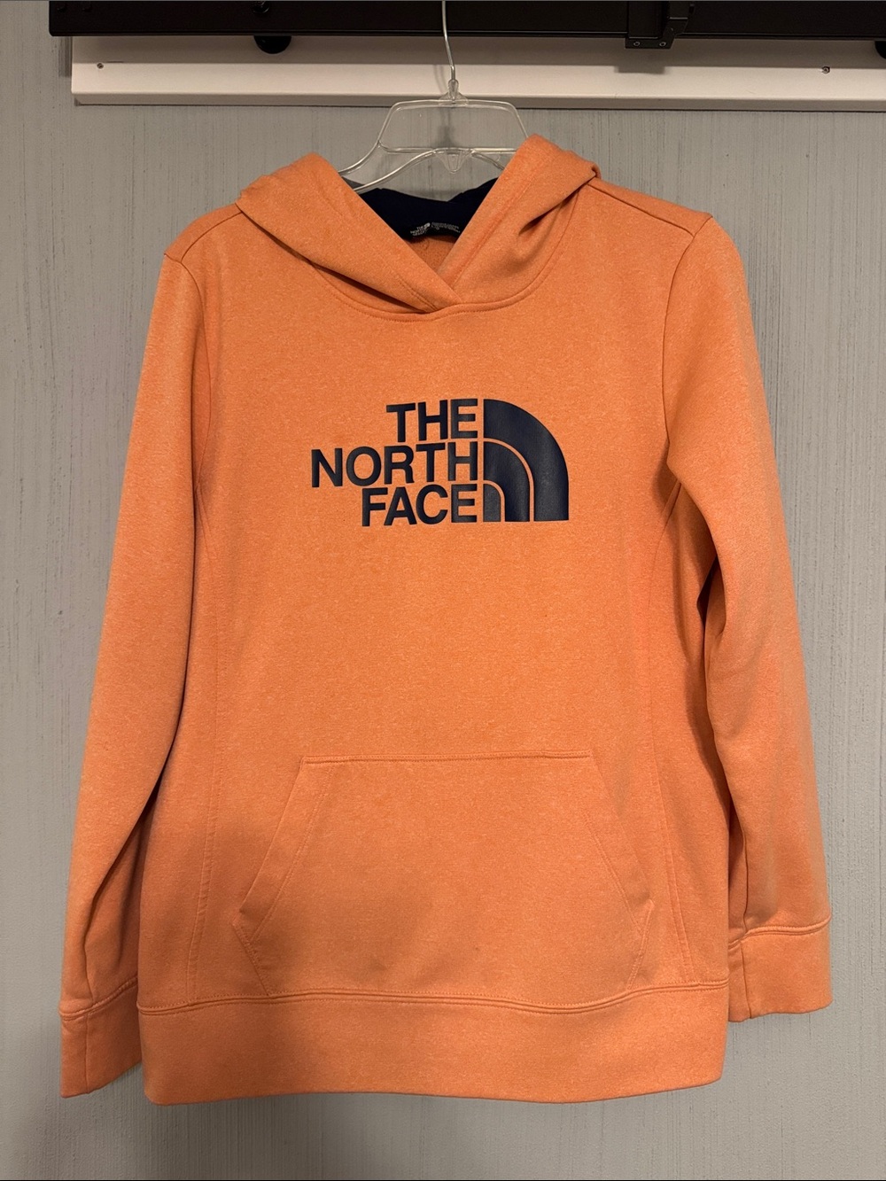 The North Face women’s peach Pullover Hoodie with Navy Logo